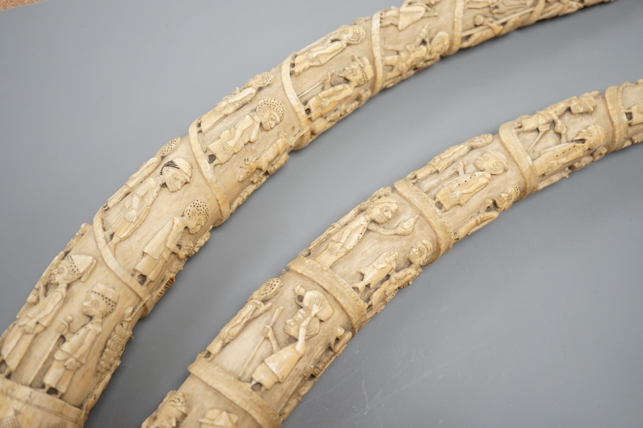 Two Loango carved ivory tusks, Republic of Congo, mid to late 19th century, 46cms long.